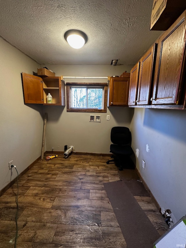 clothes washing area with a textured ceiling, hookup for a washing machine, and dark hardwood / wood-style floors