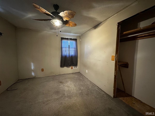 unfurnished bedroom with carpet, a textured ceiling, and ceiling fan