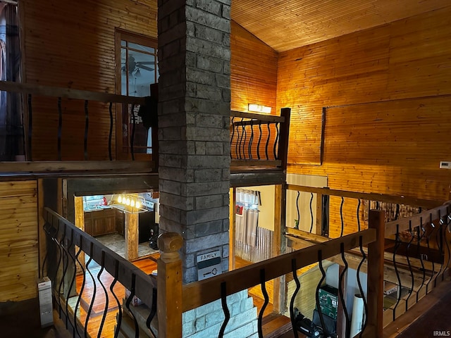 interior space with wooden ceiling, wood walls, wood-type flooring, and vaulted ceiling