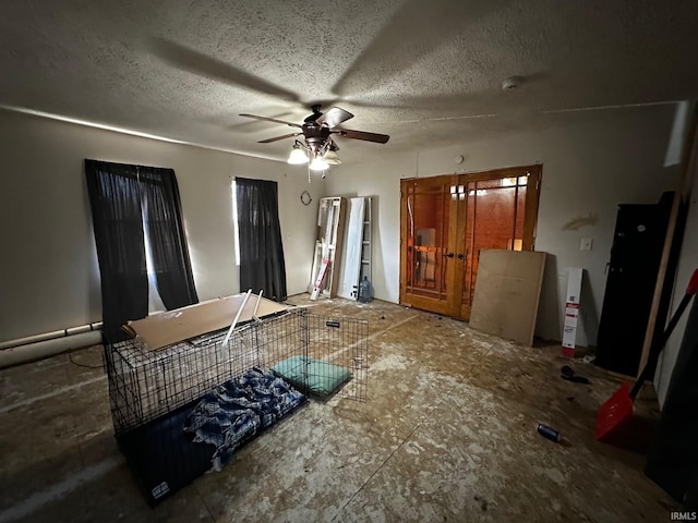 kitchen with a textured ceiling and ceiling fan