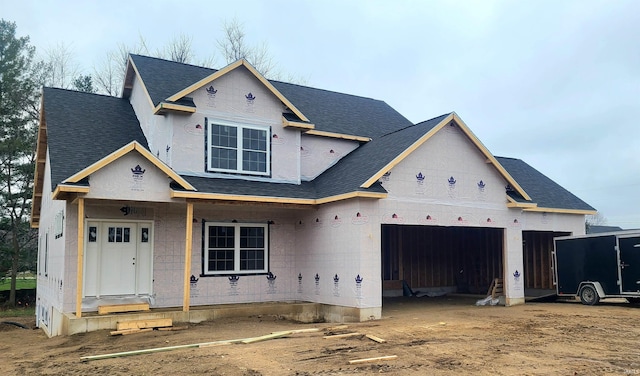 unfinished property featuring a porch and a garage