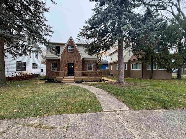 view of front of property with a front lawn and a wooden deck