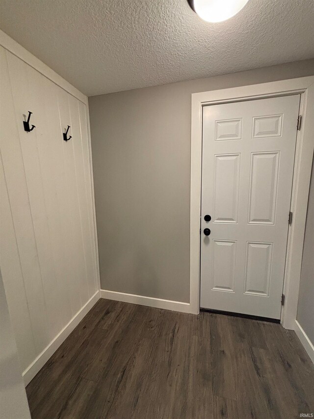 interior space with dark hardwood / wood-style flooring and a textured ceiling