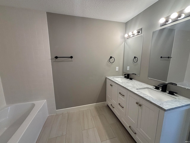 bathroom with vanity and a textured ceiling