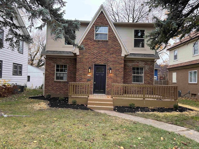 view of front of house featuring a wooden deck, central AC unit, and a front yard