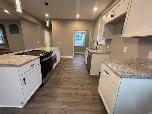 kitchen featuring sink, dark hardwood / wood-style flooring, decorative light fixtures, white cabinets, and appliances with stainless steel finishes