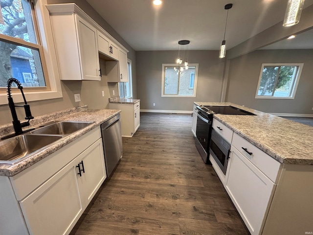 kitchen featuring a wealth of natural light, white cabinetry, and appliances with stainless steel finishes