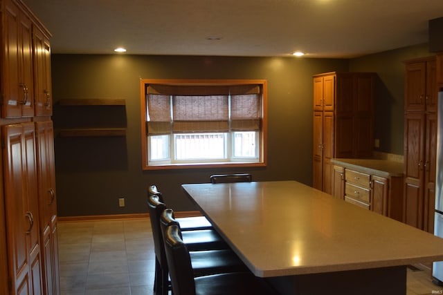 kitchen with a kitchen island and light tile patterned flooring