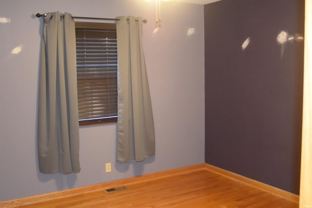 spare room featuring hardwood / wood-style floors