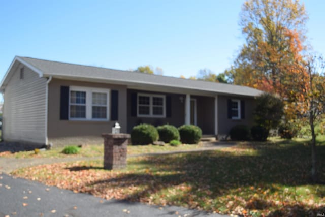 ranch-style house with a front lawn