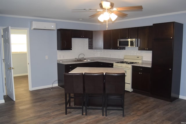 kitchen with an AC wall unit, sink, white gas range oven, ornamental molding, and dark hardwood / wood-style flooring