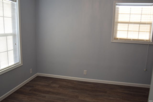 empty room with dark wood-type flooring