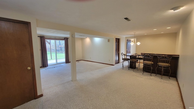 interior space featuring a notable chandelier, decorative light fixtures, and light carpet