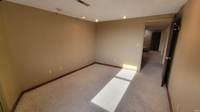 spare room with light colored carpet