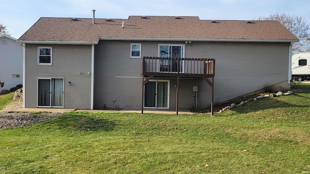 back of property featuring a lawn and a deck