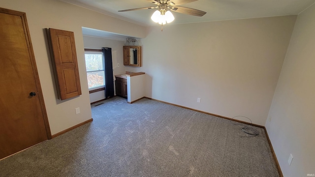 empty room featuring ceiling fan and light carpet