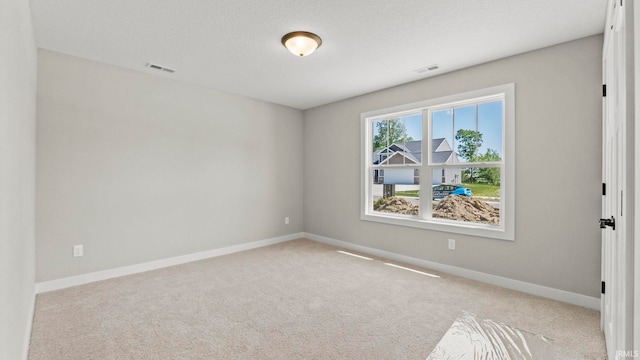 spare room with light colored carpet