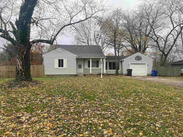 single story home featuring a front yard and a garage