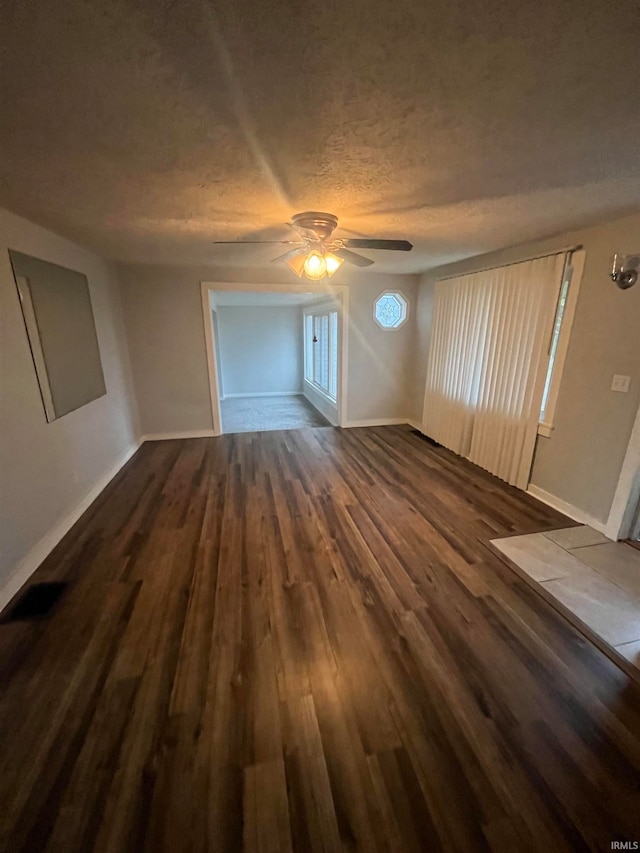 unfurnished living room with ceiling fan and hardwood / wood-style floors