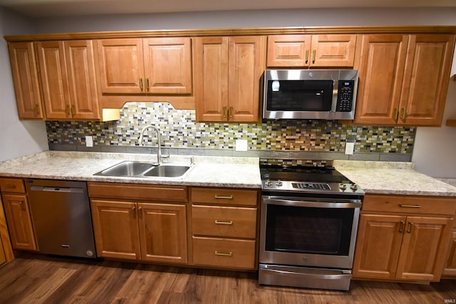 kitchen with tasteful backsplash, dark hardwood / wood-style flooring, sink, and appliances with stainless steel finishes