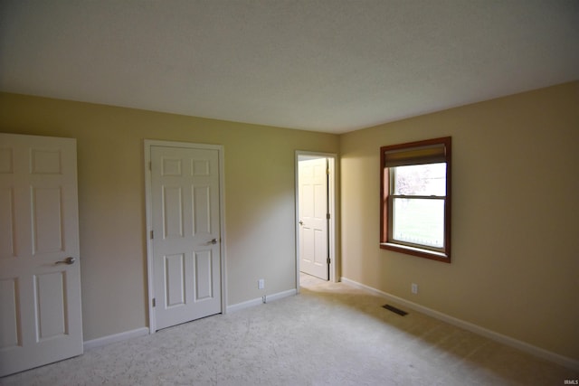 unfurnished bedroom with light carpet