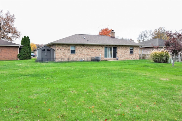 back of property featuring a yard and a storage shed