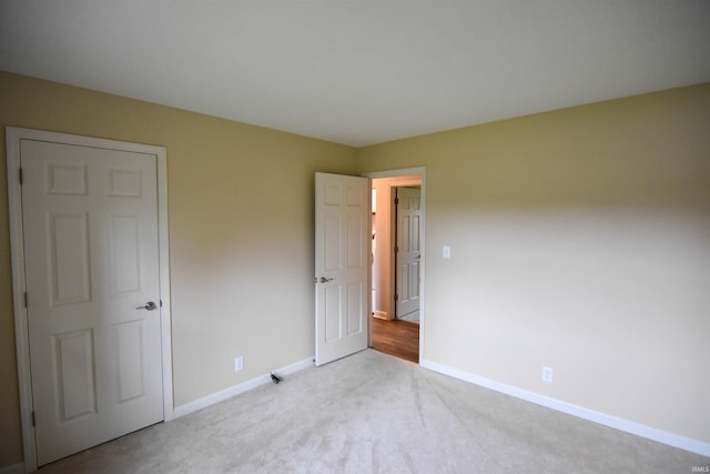 unfurnished bedroom with light carpet