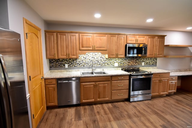 kitchen with decorative backsplash, appliances with stainless steel finishes, dark hardwood / wood-style flooring, and sink