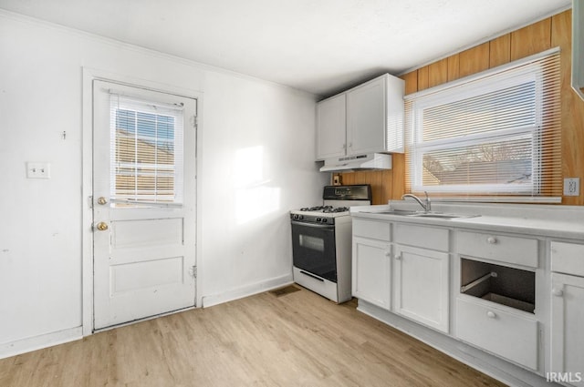 kitchen featuring white cabinetry, sink, light hardwood / wood-style flooring, exhaust hood, and white gas range oven