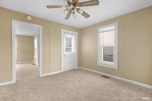 carpeted empty room featuring ceiling fan