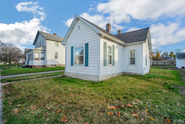 view of home's exterior with a lawn