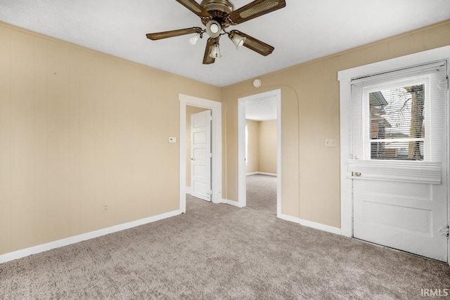 carpeted empty room featuring ceiling fan