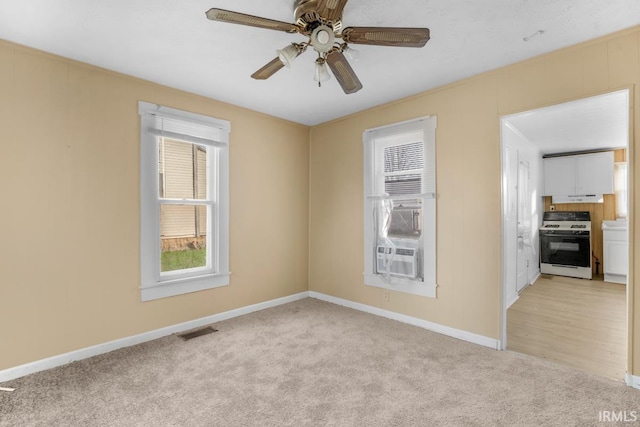 carpeted spare room featuring ceiling fan and cooling unit