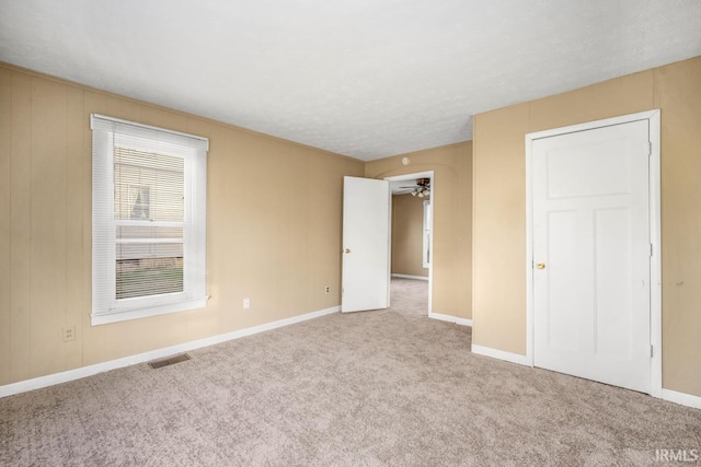 unfurnished bedroom featuring carpet flooring and a closet