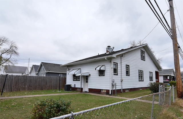 back of house with a yard and cooling unit