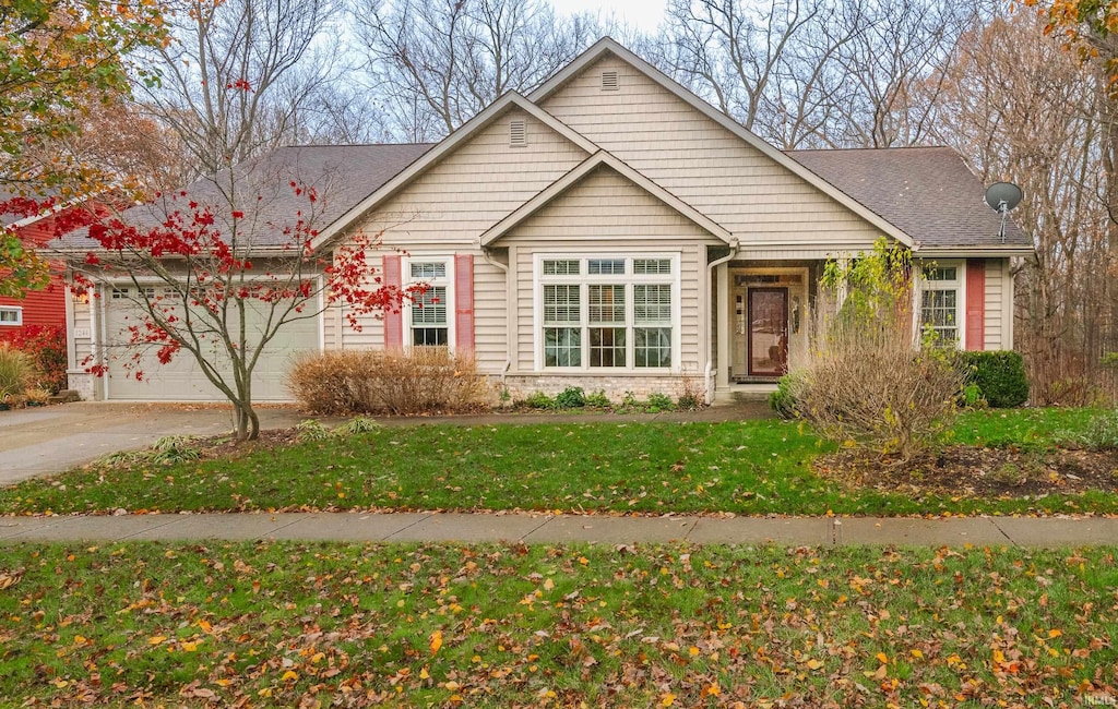 view of front of home featuring a garage and a front lawn