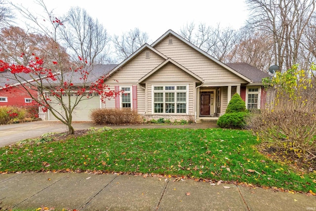 view of front of home featuring a front lawn and a garage