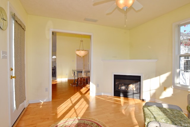 living room with hardwood / wood-style floors and ceiling fan