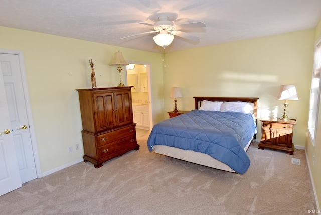 carpeted bedroom with connected bathroom and ceiling fan