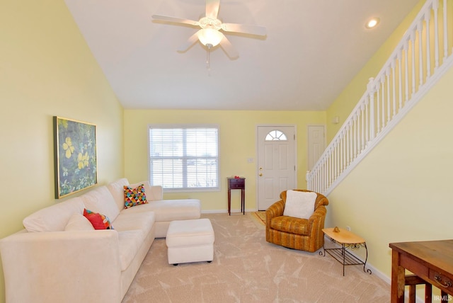 carpeted living room featuring ceiling fan and lofted ceiling