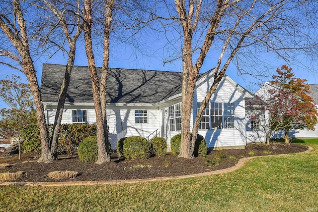 view of side of home featuring a yard