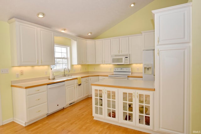 kitchen featuring white cabinetry, sink, high vaulted ceiling, white appliances, and light wood-type flooring