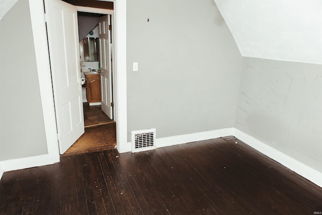 interior space featuring vaulted ceiling and dark hardwood / wood-style floors