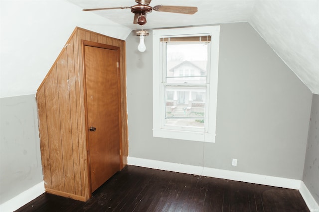 bonus room with lofted ceiling, ceiling fan, and dark wood-type flooring