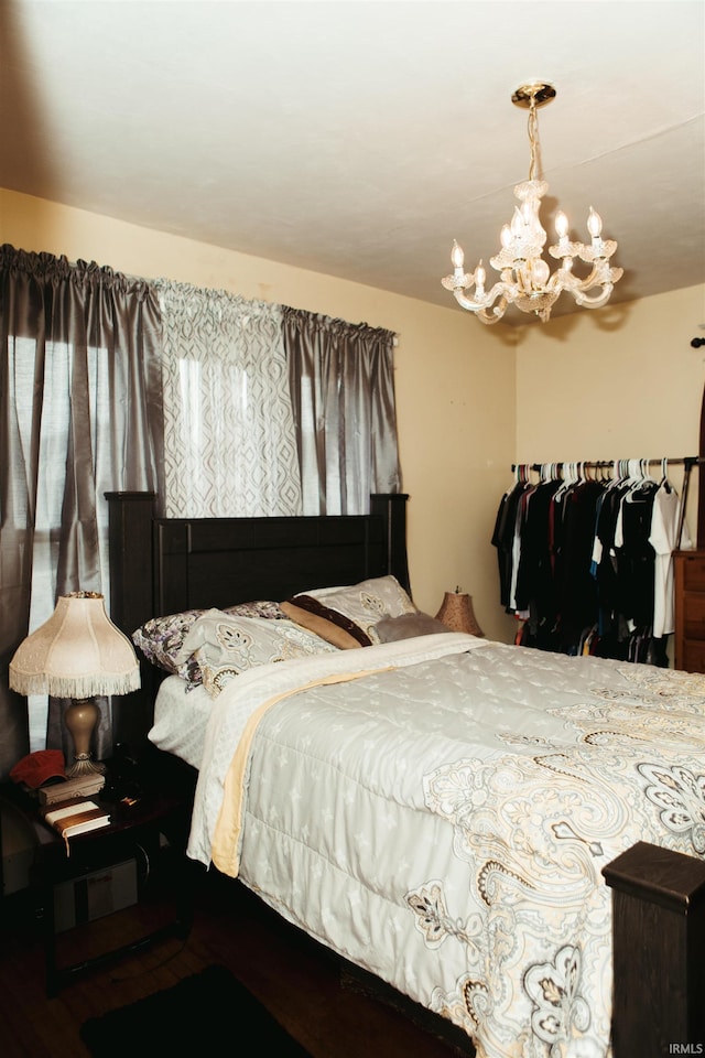 bedroom featuring a chandelier and hardwood / wood-style flooring