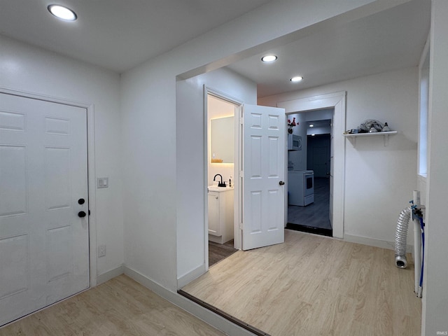 entryway with light wood-type flooring and sink