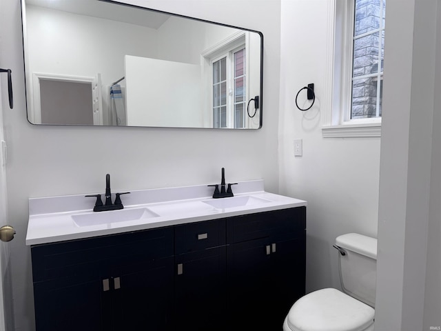 bathroom featuring vanity and toilet