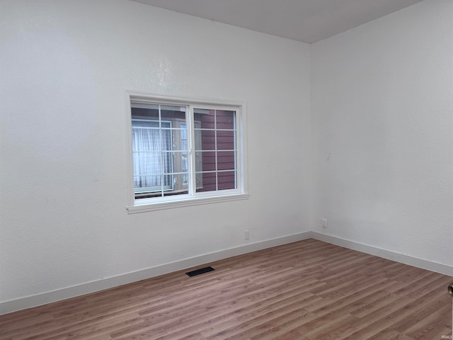 empty room with hardwood / wood-style floors