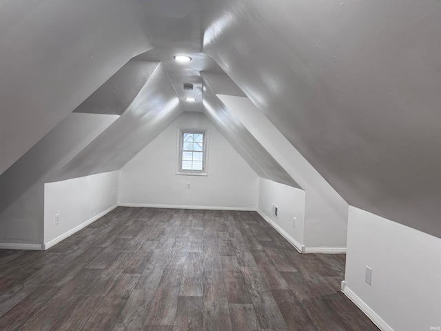 bonus room featuring lofted ceiling and dark wood-type flooring