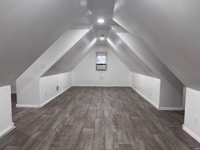 additional living space featuring dark hardwood / wood-style floors and lofted ceiling